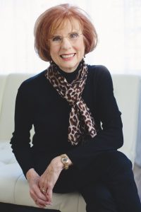 Fran Fisher seated, wearing black with scarf